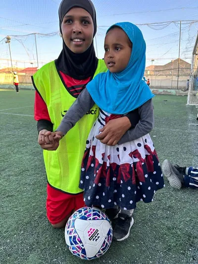Mother and daughter at football event